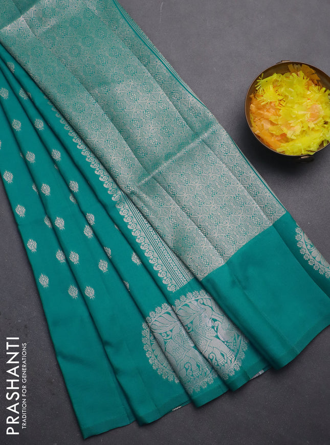 Semi soft silk saree green with allover zari woven buttas and zari woven butta border