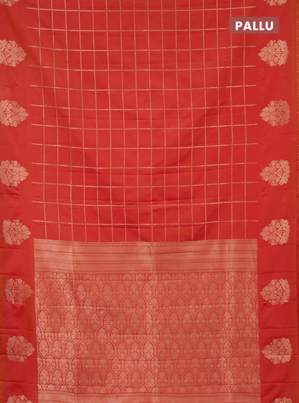 Semi soft silk saree dual shade of pinkish orange with allover zari woven checked pattern with zari woven butta border