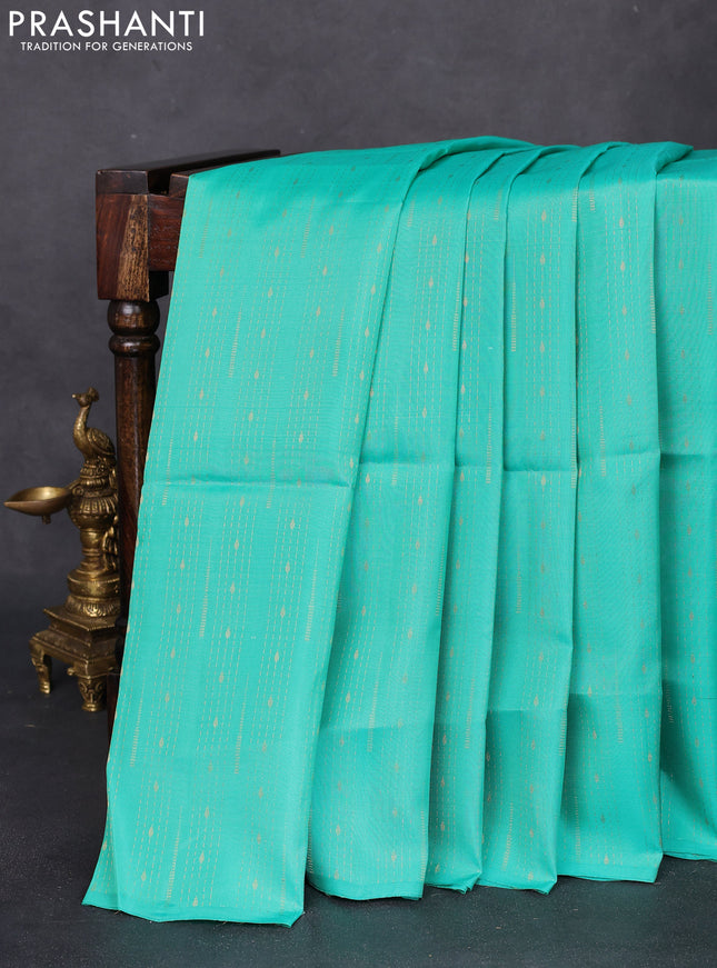 Kanchipuram silk saree teal green shade and dual shade of orange with allover zari weaves in borderless style