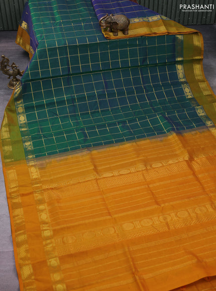 Silk cotton saree dual shade of bluish green and mustard yellow with allover zari checked pattern and rettapet zari woven border