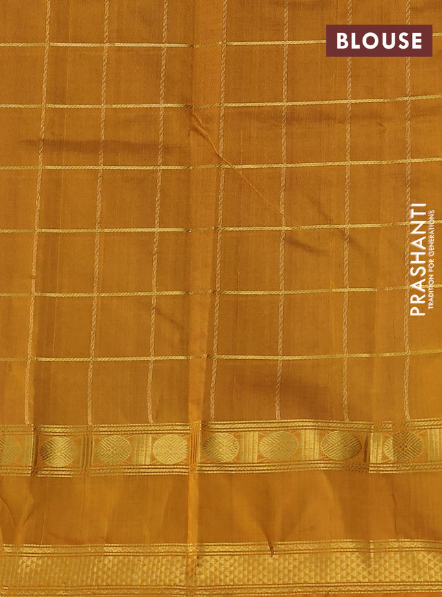 Silk cotton saree dual shade of bluish green and mustard yellow with allover zari checked pattern and rettapet zari woven border