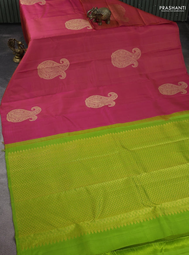Pure kanchipuram silk saree dual shade of pinkish orange and light green with paisley zari woven buttas in borderless style