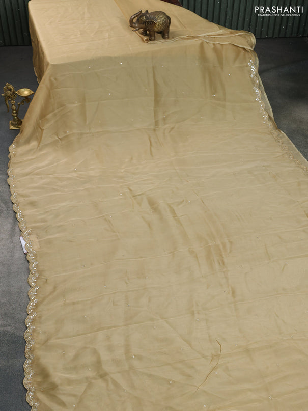 Satin crepe silk saree sandal and blue with mirror work and ajrakh printed blouse