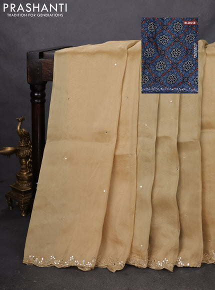 Satin crepe silk saree sandal and blue with mirror work and ajrakh printed blouse