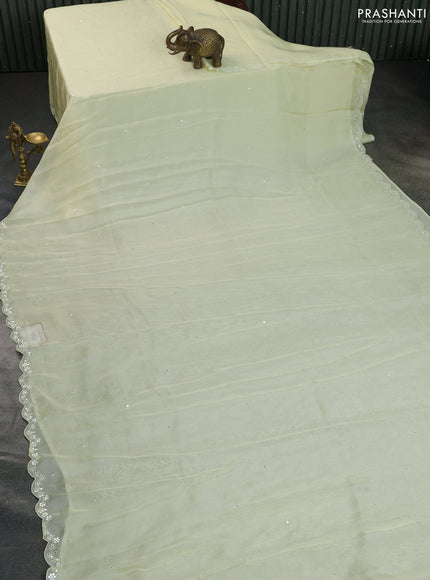 Satin crepe silk saree pale yellow and black with mirror work and ajrakh printed blouse