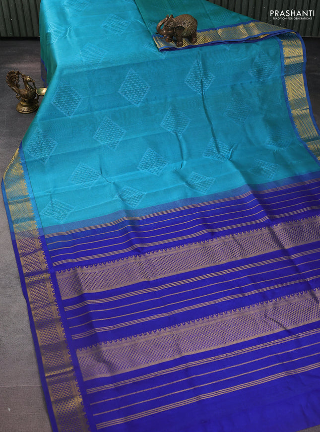 Silk cotton saree teal blue and blue with allover self emboss jacquard and zari woven border