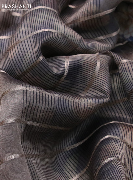 Tissue saree dual shade of grey and black with allover zari woven stripes pattern and zari woven border - printed blouse
