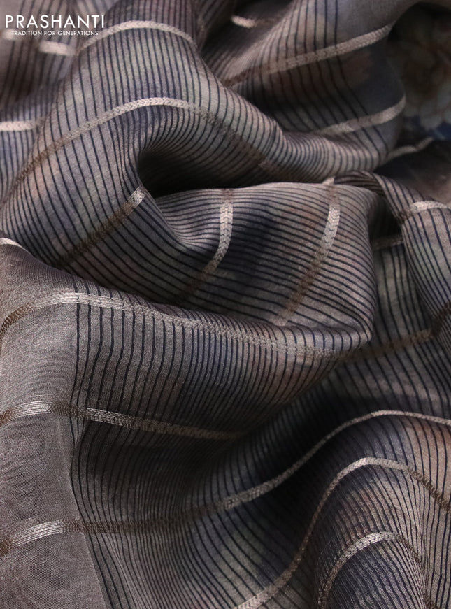 Tissue saree dual shade of grey and black with allover zari woven stripes pattern and zari woven border - printed blouse