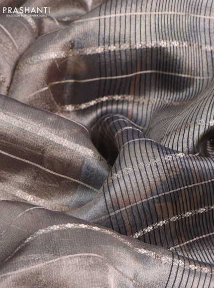 Tissue saree dual shade of grey and black with allover zari woven stripes pattern and zari woven border - printed blouse