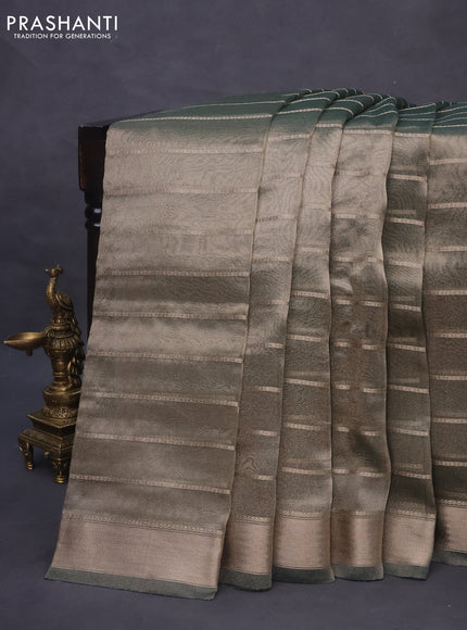 Tissue saree dual shade of green and green with allover zari woven stripes pattern and zari woven border - printed blouse