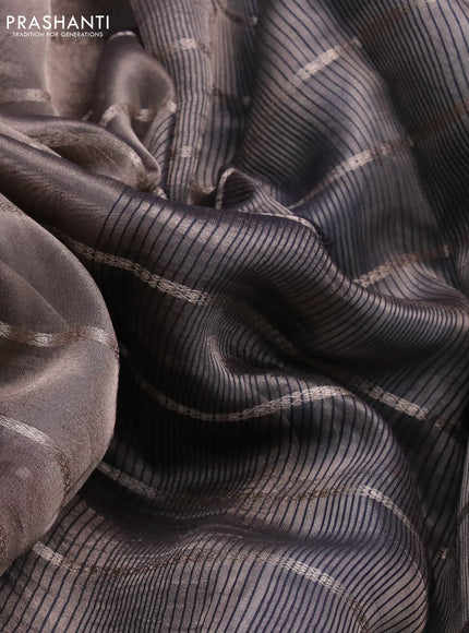 Tissue saree dual shade of grey and black with allover zari woven stripes pattern and zari woven border - printed blouse