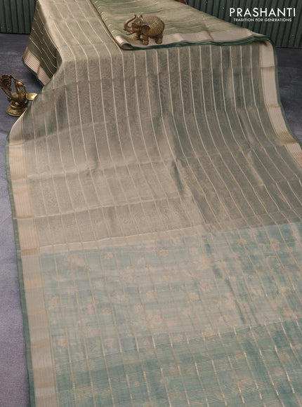 Tissue saree dual shade of green and green with allover zari woven stripes pattern and zari woven border - printed blouse