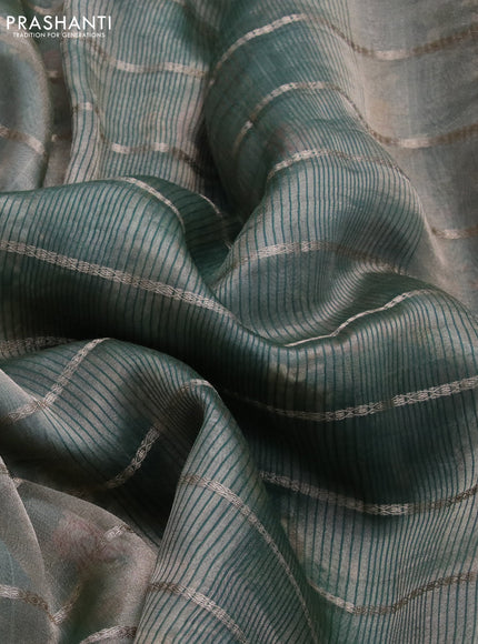 Tissue saree dual shade of green and green with allover zari woven stripes pattern and zari woven border - printed blouse