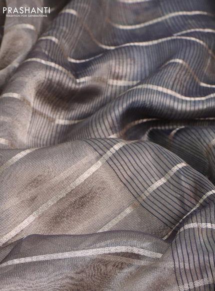 Tissue saree grey shade and black with allover zari woven stripes pattern and zari woven border - printed blouse