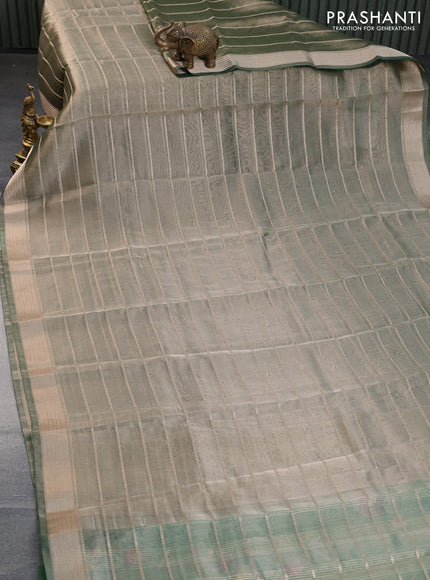 Tissue saree dual shade of green and green with allover zari woven stripes pattern and zari woven border - printed blouse