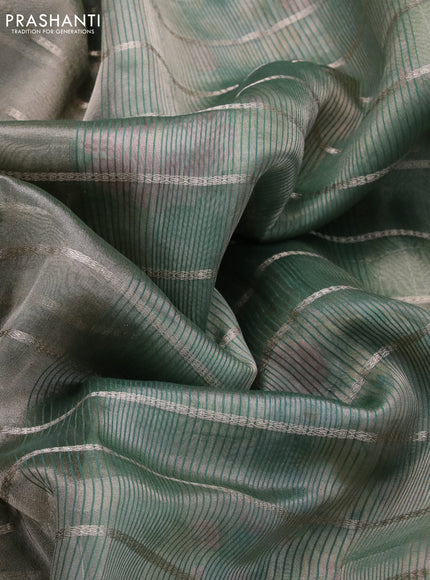 Tissue saree dual shade of green and green with allover zari woven stripes pattern and zari woven border - printed blouse