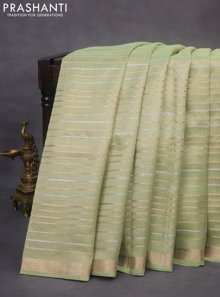 Tissue organza saree pista green with allover silver & gold zari weaves and zari woven border