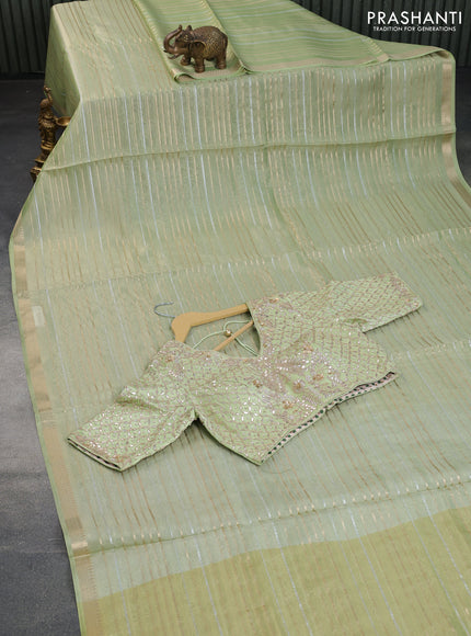 Tissue organza saree pista green with allover silver & gold zari weaves and zari woven border
