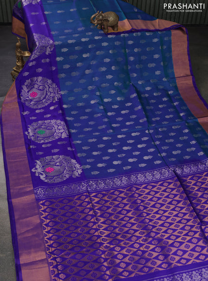 Pure uppada silk saree dual shade of bluish green and violet with allover silver zari woven buttas and long paisley design zari woven border
