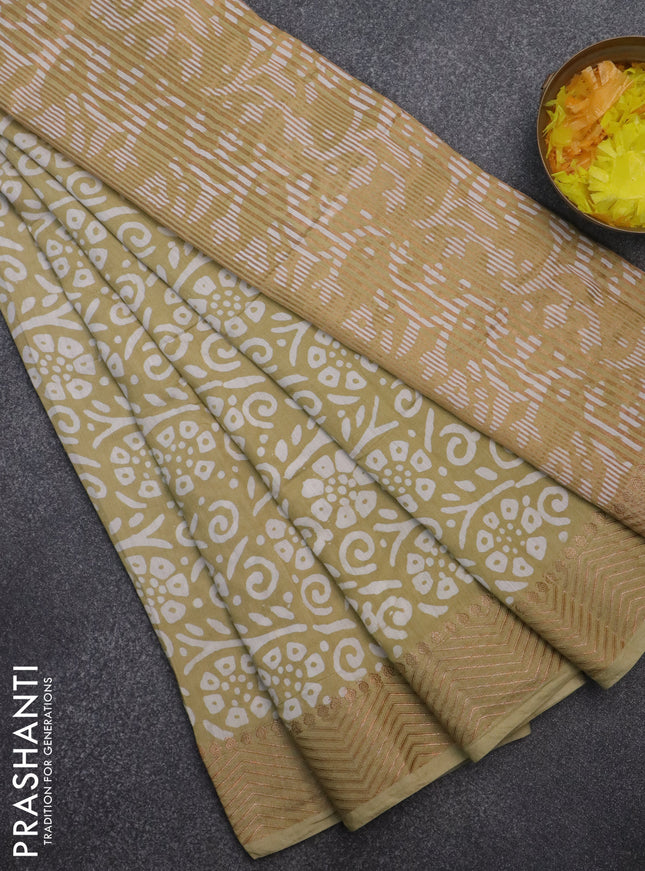 Semi chanderi saree sandal and off white with allover batik prints and zari woven border