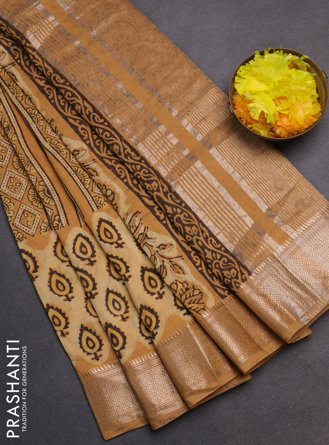 Semi chanderi saree sandal and pale orange with allover vanaspathi prints and zari woven border