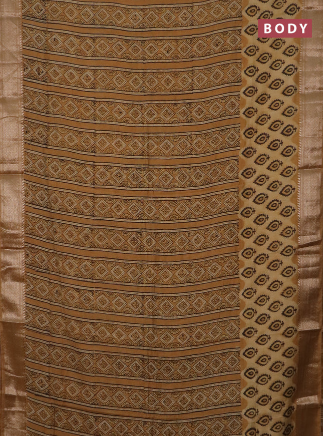 Semi chanderi saree sandal and pale orange with allover vanaspathi prints and zari woven border