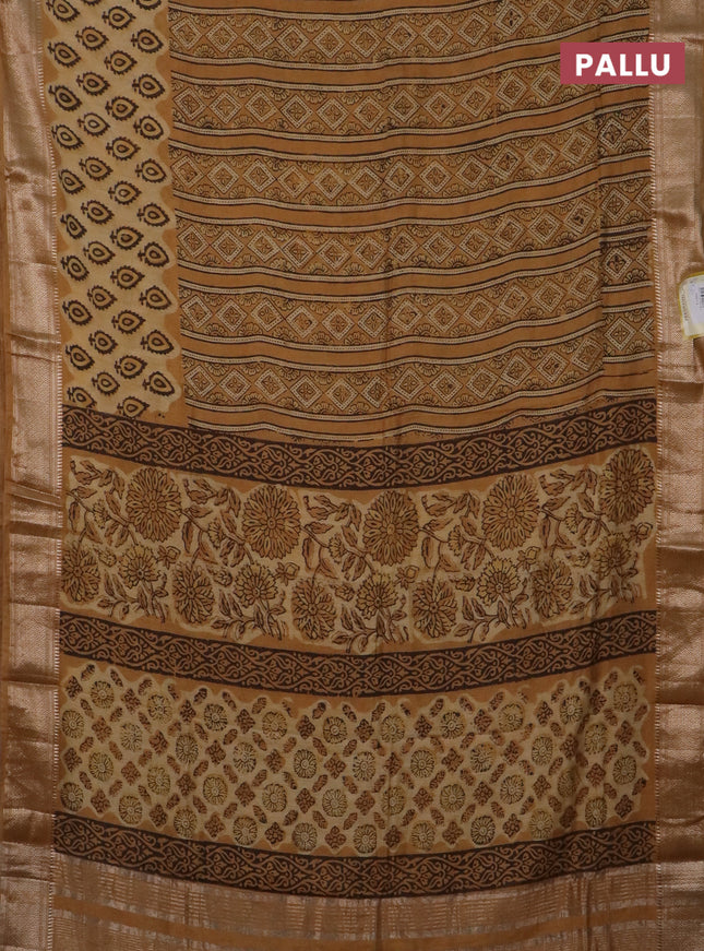 Semi chanderi saree sandal and pale orange with allover vanaspathi prints and zari woven border