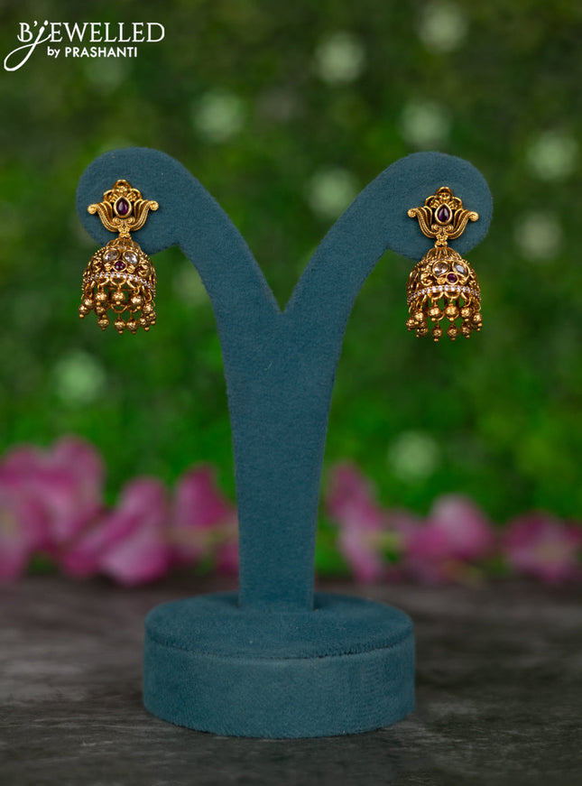 Antique jhumkas with pink kemp & cz stones and golden beads hangings