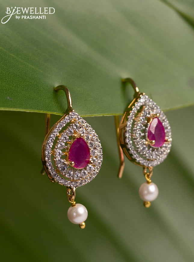 Bugadi earrings with ruby & cz stones and pearl hanging in gold finish