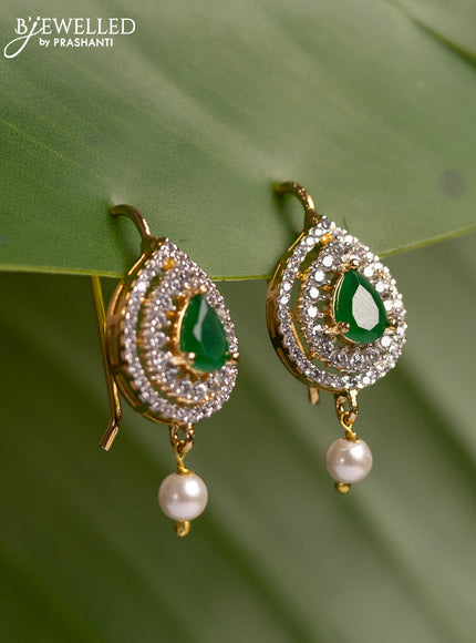 Bugadi earrings with emerald & cz stones and pearl hanging in gold finish
