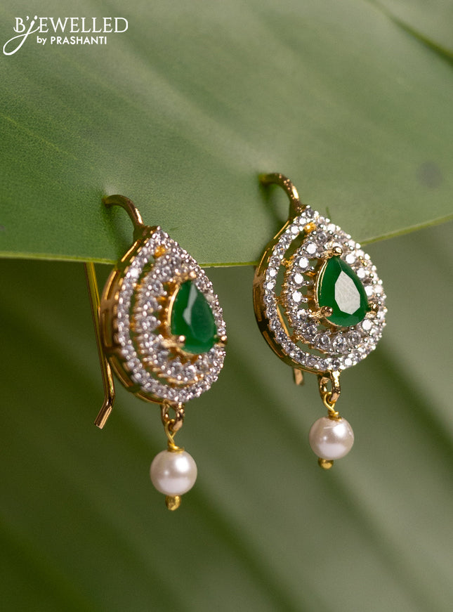 Bugadi earrings with emerald & cz stones and pearl hanging in gold finish