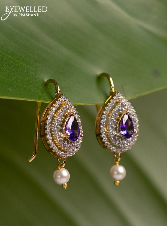 Bugadi earrings with violet & cz stones and pearl hanging in gold finish