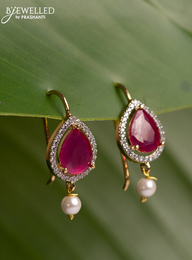 Bugadi earrings with ruby & cz stones and pearl hanging in gold finish