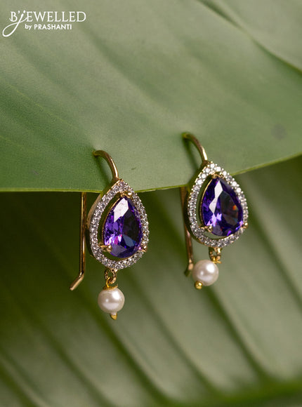 Bugadi earrings with violet & cz stones and pearl hanging in gold finish