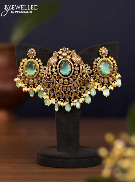 Pendant set parrot design with mint green & cz stones and pearl & beads hangings in victorian finish