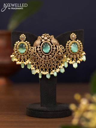 Pendant set parrot design with mint green & cz stones and pearl & beads hangings in victorian finish