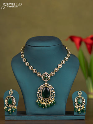 Necklace with emerald & kundan cz stones and pearl & green beads hangings in victorian finish