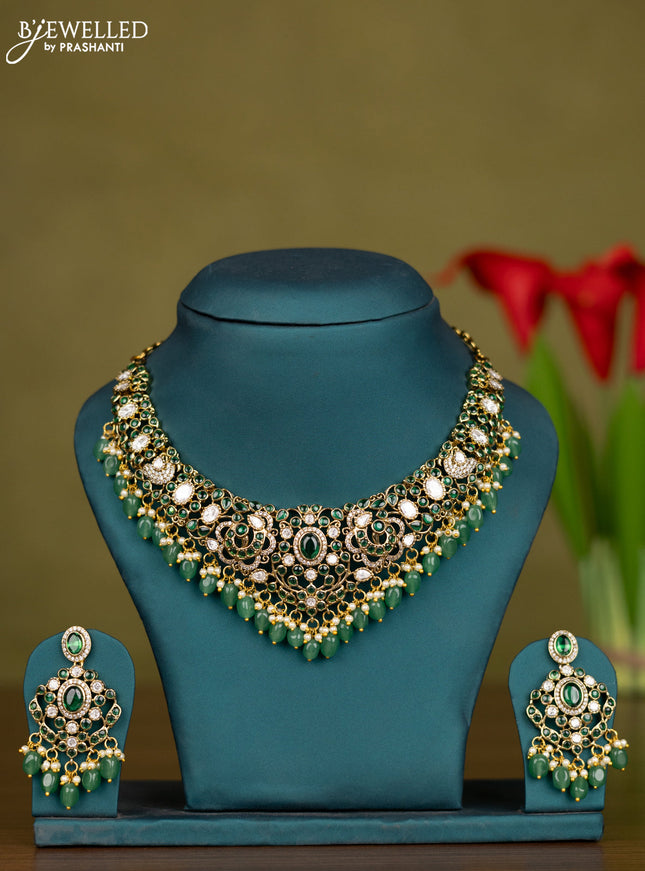 Necklace with emerald & kundan cz stones and green beads hangings in victorian finish