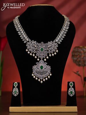Zircon haaram with emerald & cz stones and pearl hangings in gold finish