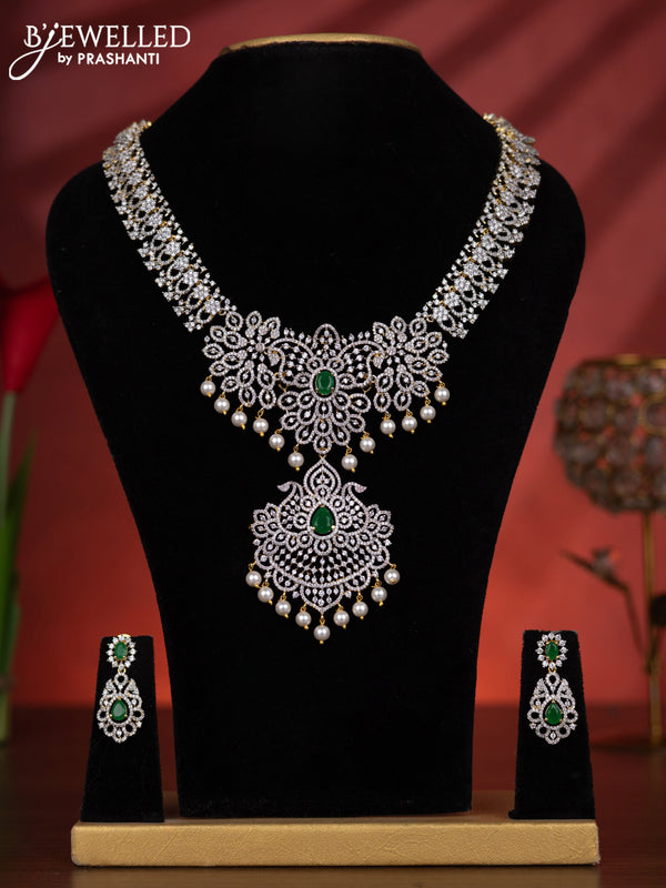 Zircon haaram with emerald & cz stones and pearl hangings in gold finish