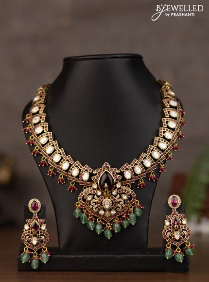 Necklace peacock design with pink kundan stones and natural beads hanging in victorian finish