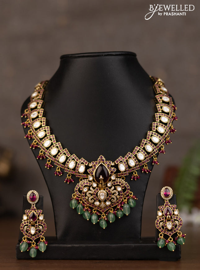 Necklace peacock design with pink kundan stones and natural beads hanging in victorian finish