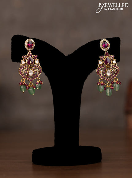 Necklace peacock design with pink kundan stones and natural beads hanging in victorian finish