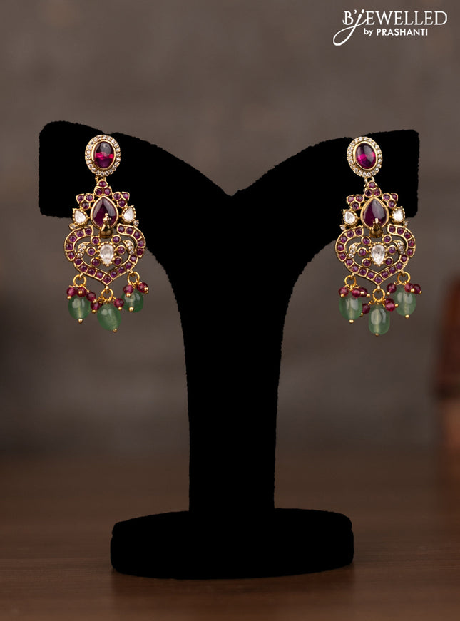 Necklace peacock design with pink kundan stones and natural beads hanging in victorian finish