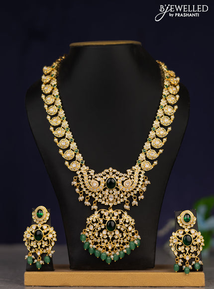 Zircon necklace with green kemp cz stones and green beads & pearl hangings in gold finish