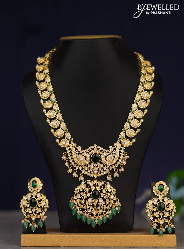 Zircon necklace with green kemp cz stones and green beads & pearl hangings in gold finish