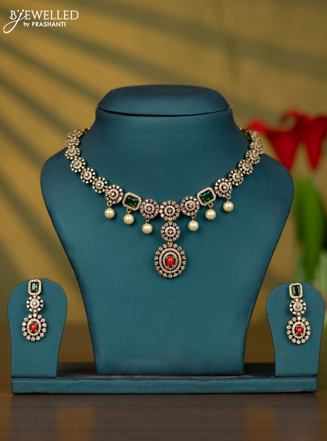 Necklace with pavalam & emerald cz stones and pearl hangings in victorian finish
