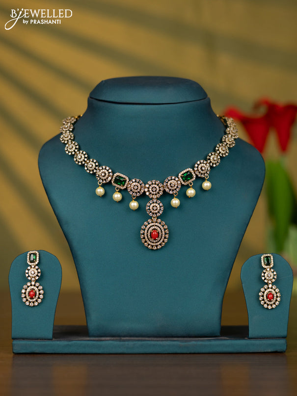 Necklace with pavalam & emerald cz stones and pearl hangings in victorian finish