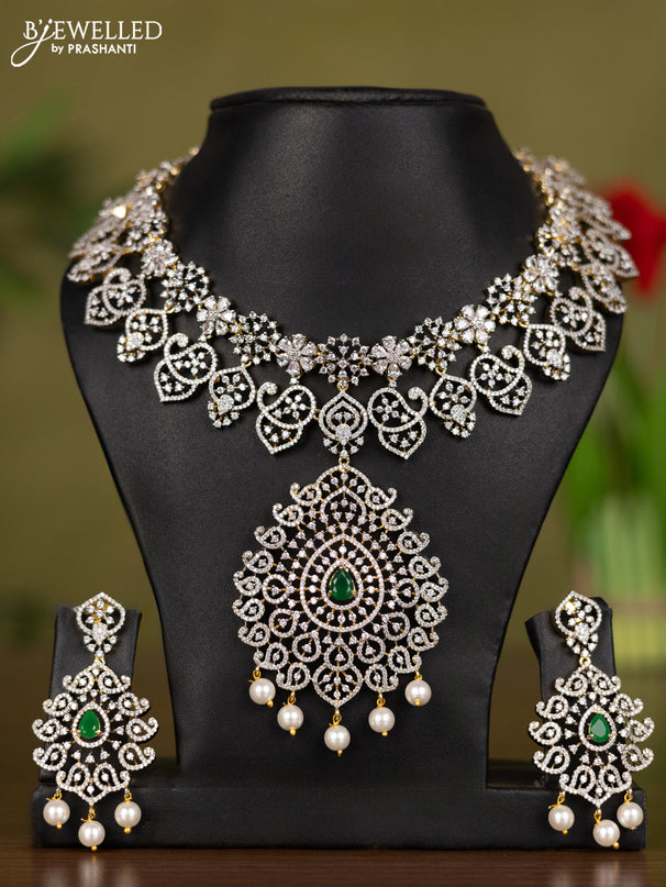 Zircon necklace with emerald & cz stones and pearl hangings in gold finish