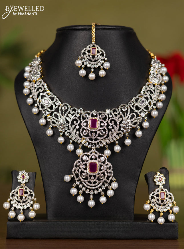 Zircon necklace with maang tikka ruby & cz stones and pearl hangings in gold finish
